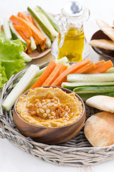 Hummus with pita bread and fresh vegetables, vertical — Stock Photo, Image