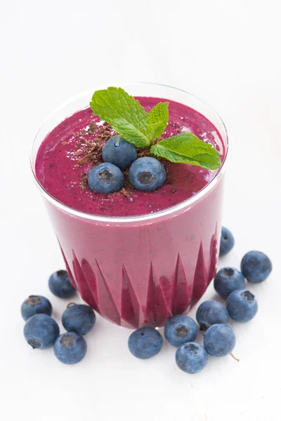 Blueberry milkshake in a glass on white table, close-up — Stock Photo, Image