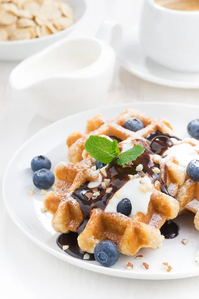 Waffles with blueberries, cream and chocolate sauce, vertical — Stock Photo, Image