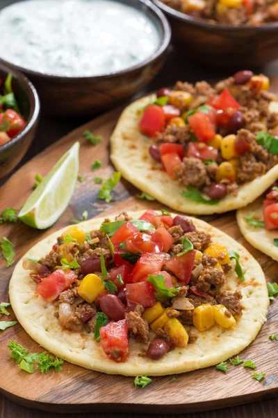 Tortillas with chili con carne and tomato salsa on wooden board — Stock Photo, Image