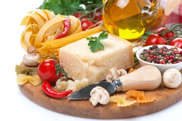 Parmesan, spices, olive oil, pasta and herbs on board, isolated Stock Picture