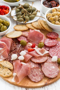 Assorted meat snacks, sausages and pickles, top view, close-up