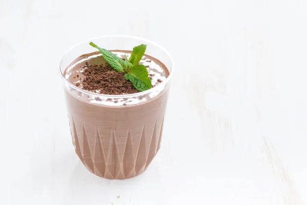 Chocolate milkshake in a glass on white wooden table — Stock Photo, Image