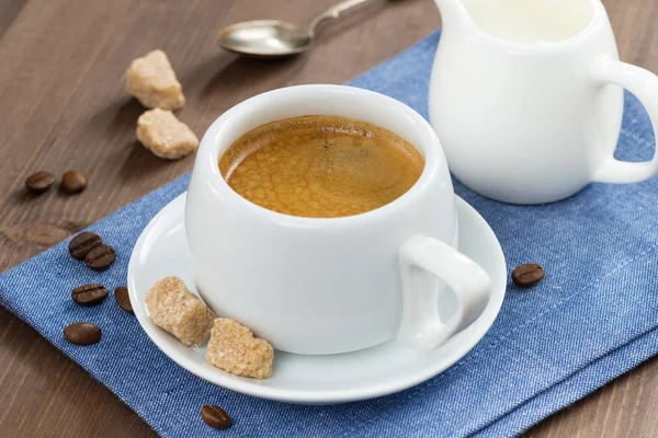 Cup of coffee with sugar and milk jug — Stock Photo, Image