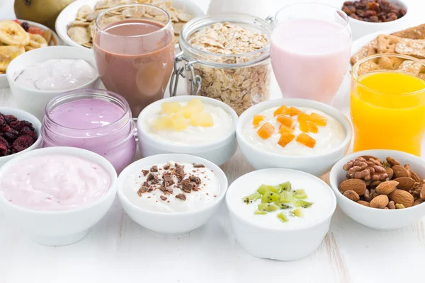 Assorted fruit yoghurts and breakfast ingredients — Stock Photo, Image