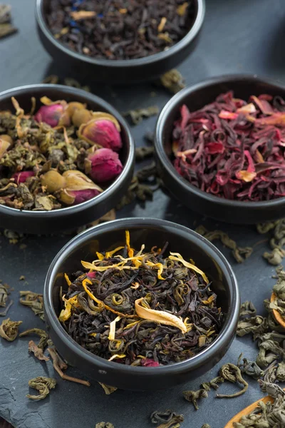 Assortment of dry tea in ceramic bowls, close-up, top view — Stock Photo, Image