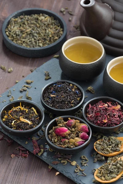 Választék illatos szárított tea és zöld tea, felülnézet, függőlegesen — Stock Fotó