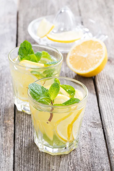 Limonade à la menthe rafraîchissante sur une table en bois, verticale — Photo