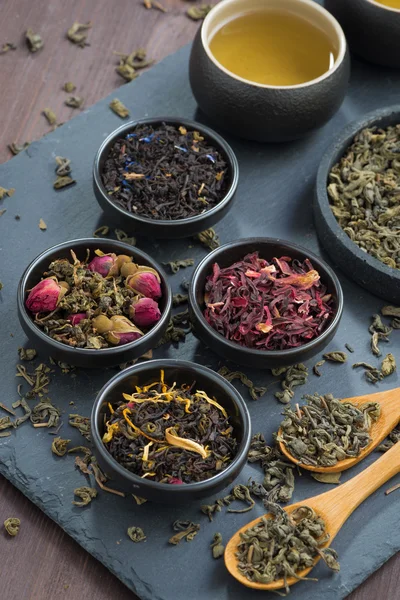 Assortment of dry tea in bowls, top view — Stock Photo, Image