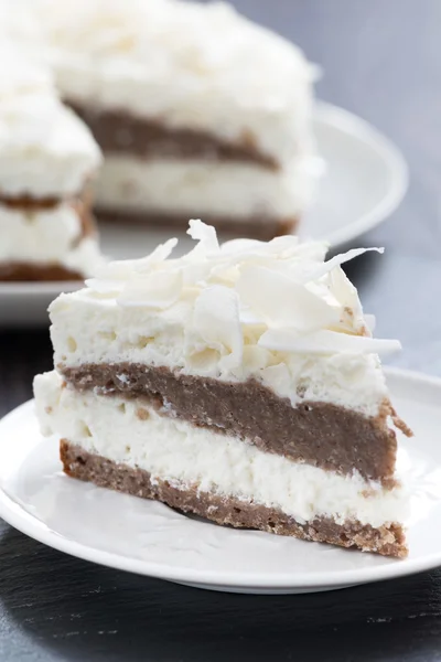 Piece of chocolate cake with coconut cream, close-up — Stock Photo, Image