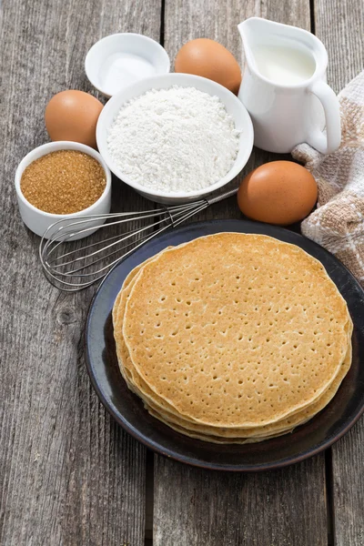 Crepes and ingredients for their preparation, vertical, top view — Stock Photo, Image