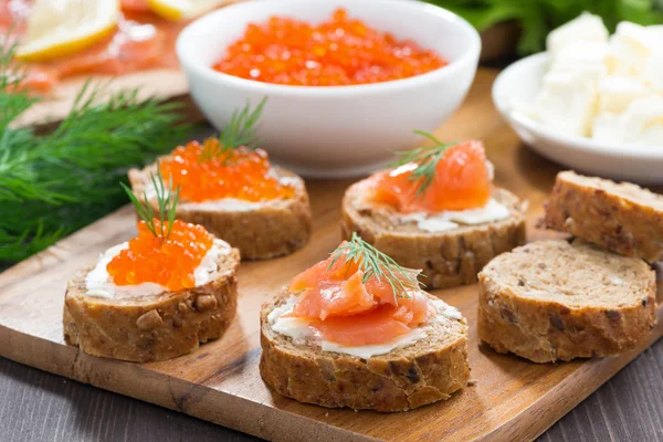 Appetizers - toast with salted salmon and red caviar — Stock Photo, Image