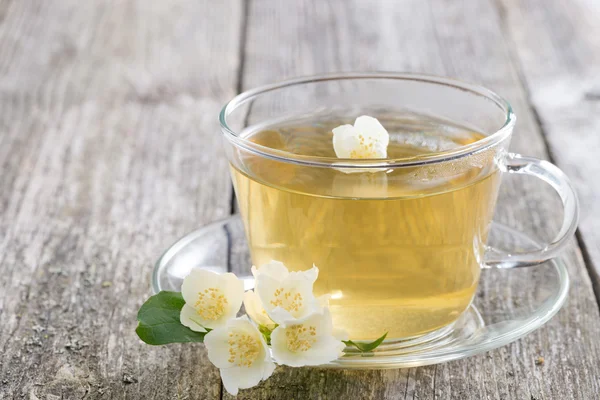 Cup of green tea with jasmine on wooden table, horizontal — Stock Photo, Image