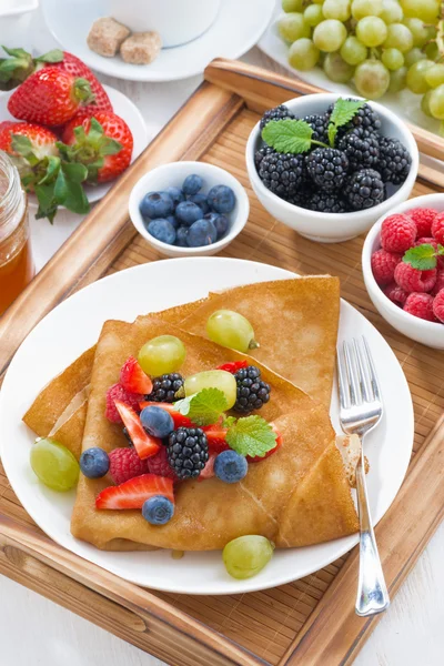 Delicious breakfast - crepes with fresh berries and honey — Stock Photo, Image