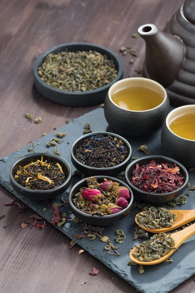 Assortment of fragrant dried teas and green tea, vertical — Zdjęcie stockowe