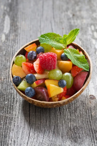Fruit salad in a bamboo bowl, vertical — Stock Photo, Image