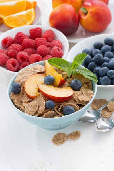 Whole-grain flakes with fruit and berries, vertical, top view — Stockfoto