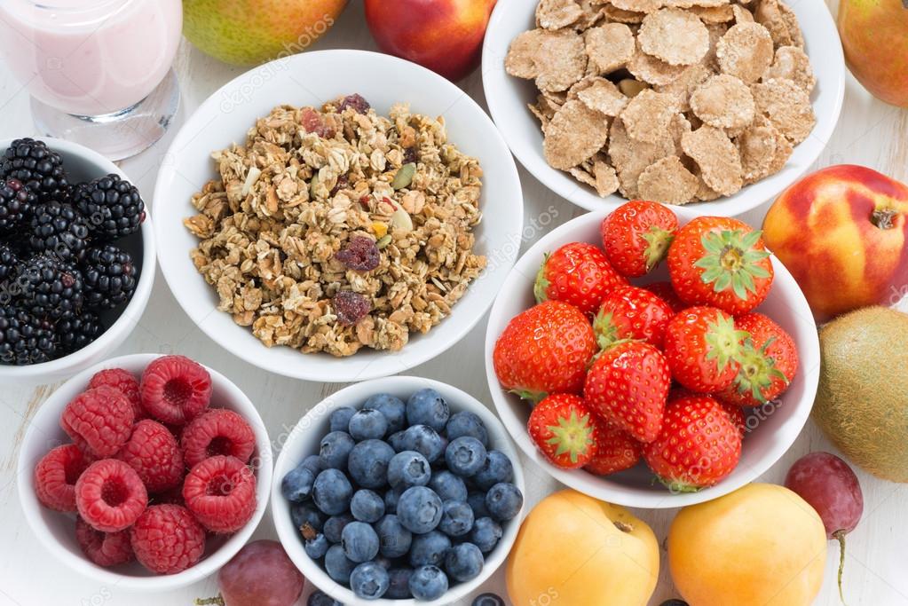 fresh berries, fruit and muesli, top view