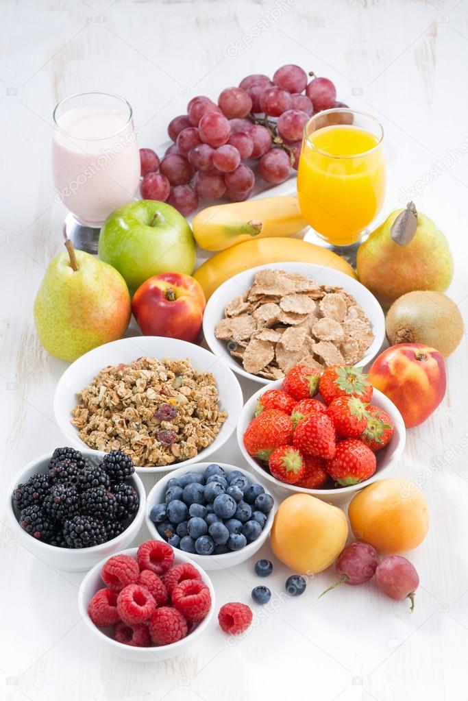 fresh berries, fruit and muesli for breakfast, vertical