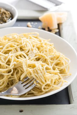 Plate of spaghetti with pesto and cheese