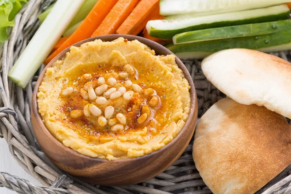 Hummus with pita bread and fresh vegetables, top view — Stok fotoğraf