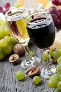 red and white wine, grapes, nuts and cheeses