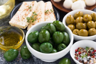 snacks - green olives and soft cheeses, close-up clipart