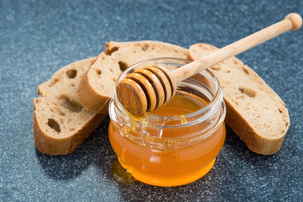 Jar with honey and bread — Stock Photo, Image