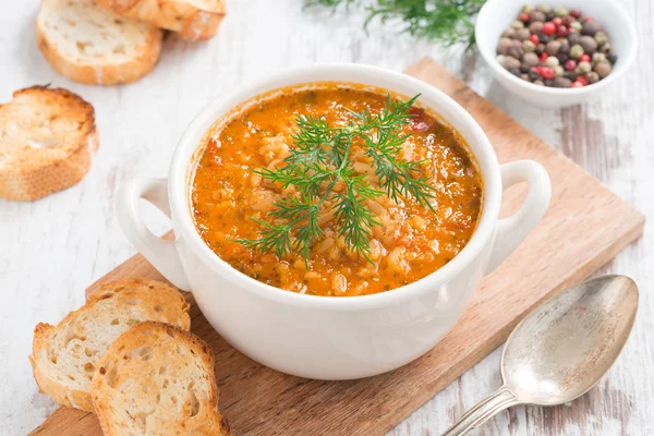 Tomato soup with rice and vegetables in a white saucepan — Stock Image Tomato soup with rice and vegetables in a white saucepan Royalty Free Stock Photos