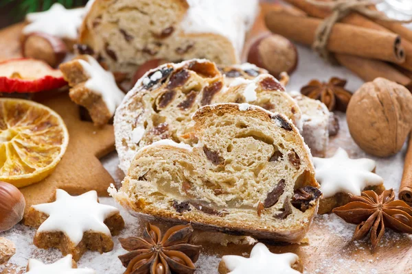 Christmas Stollen with dried fruit, assorted cookies and spices — Stock Photo, Image