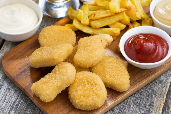 Chicken nuggets with french fries and different sauces — Stock Photo, Image