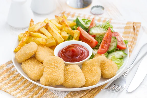 Fast food lunch with chicken nuggets, french fries and vegetable — Stock Photo, Image