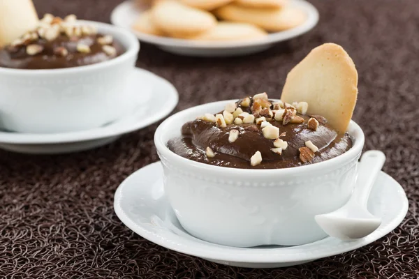 Chocolate mousse with biscuits in white cups — Stock Photo, Image