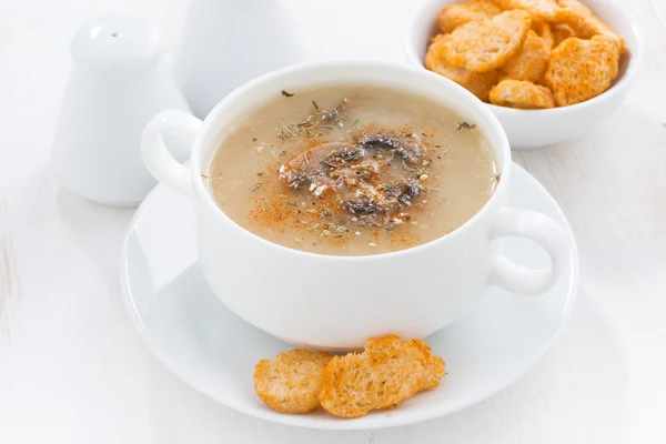 Mushroom cream soup with croutons on white table — Stock Photo, Image