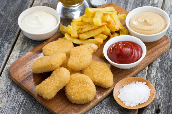 Chicken nuggets with french fries and different sauces — Stock Photo, Image