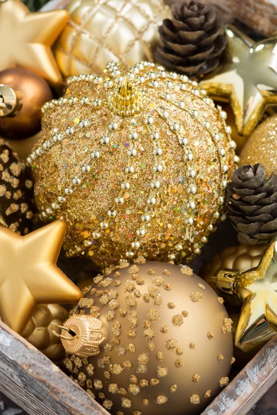 Golden Christmas decorations in a box, closeup — Stock Photo, Image