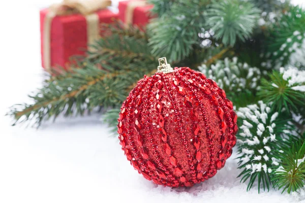 Christmas composition with red ball and gifts — Stock Photo, Image