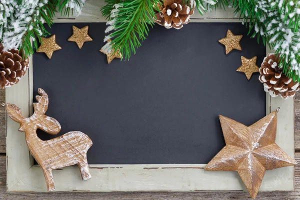 Christmas concept. Black board for text and wooden ornaments — Stock Photo, Image