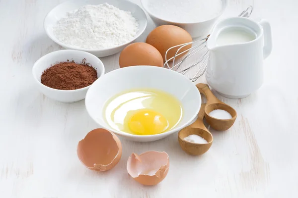 Fresh ingredients for baking on a white table, horizontal — Stock Photo, Image