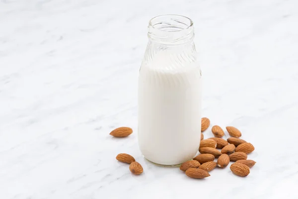 Almond milk in a glass bottle — Stock Photo, Image