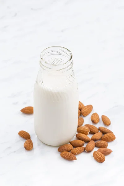 Almond milk in a glass bottle, vertical, top view — Stock Photo, Image