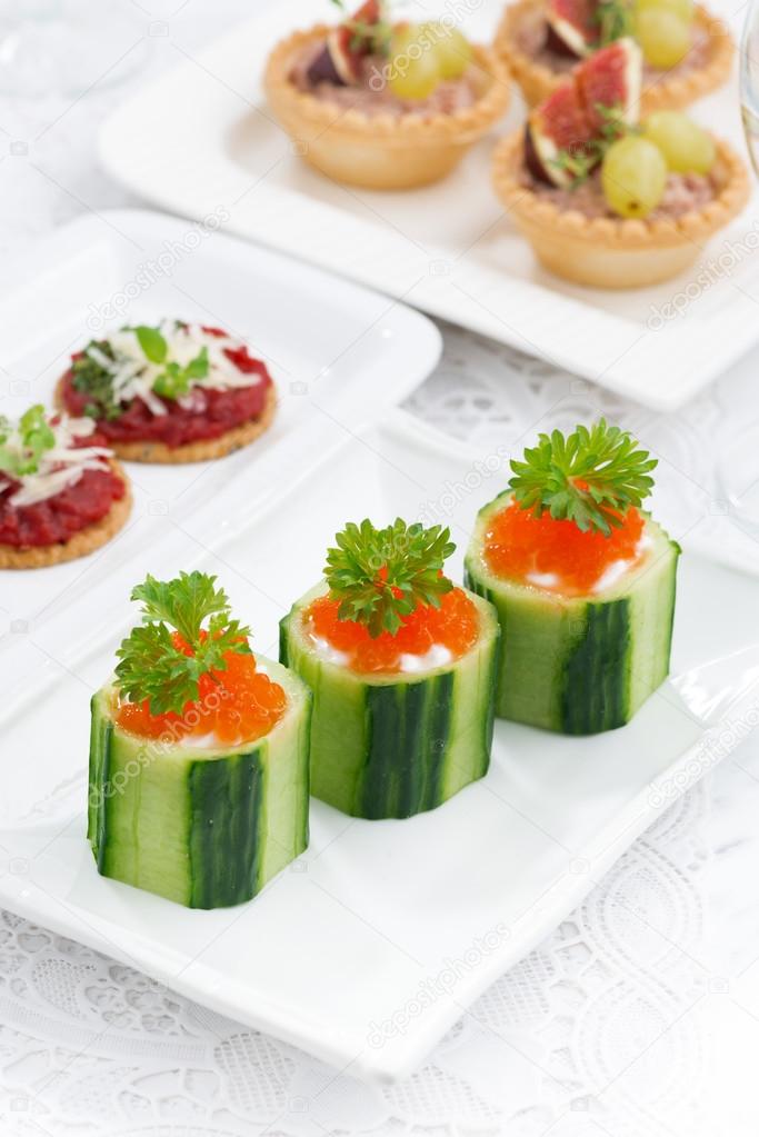 cucumber tartlets with cream cheese and red caviar for holiday