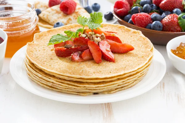 Delicious crepes with strawberries and honey — Stock Photo, Image