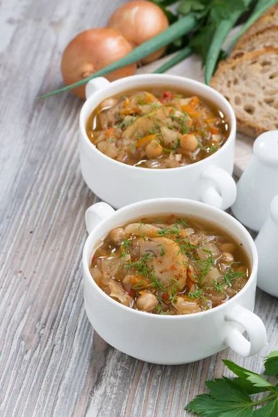 Soup with cabbage, mushrooms and chickpeas on wooden background — Stock Photo, Image