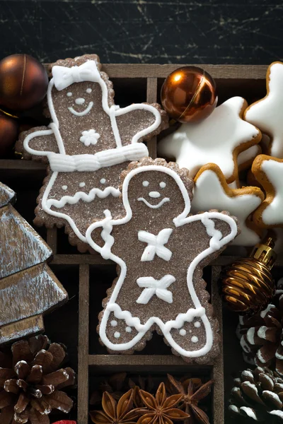 Christmas symbols and cookies in a wooden box, vertical — Stock Photo, Image