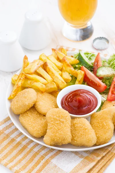 Fast food - chicken nuggets, french fries and vegetable salad — Stock Photo, Image