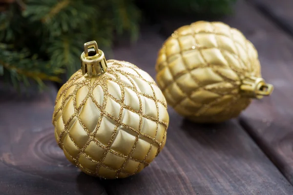 Golden Christmas balls on the background of fir branches — Stock Photo, Image