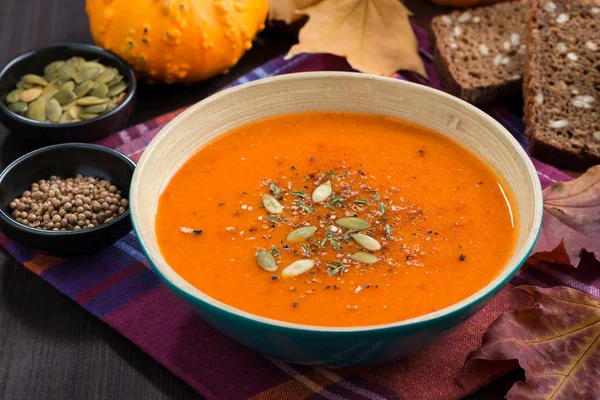 Pumpkin soup in a bowl on wooden table — Stock Photo, Image