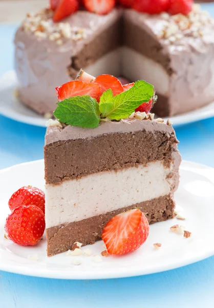 Piece of chocolate cake of three layers on plate, close-up — Stock Photo, Image