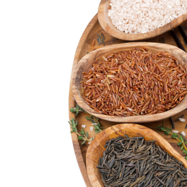 three kinds of rice and thyme in a wooden bowl on a tray